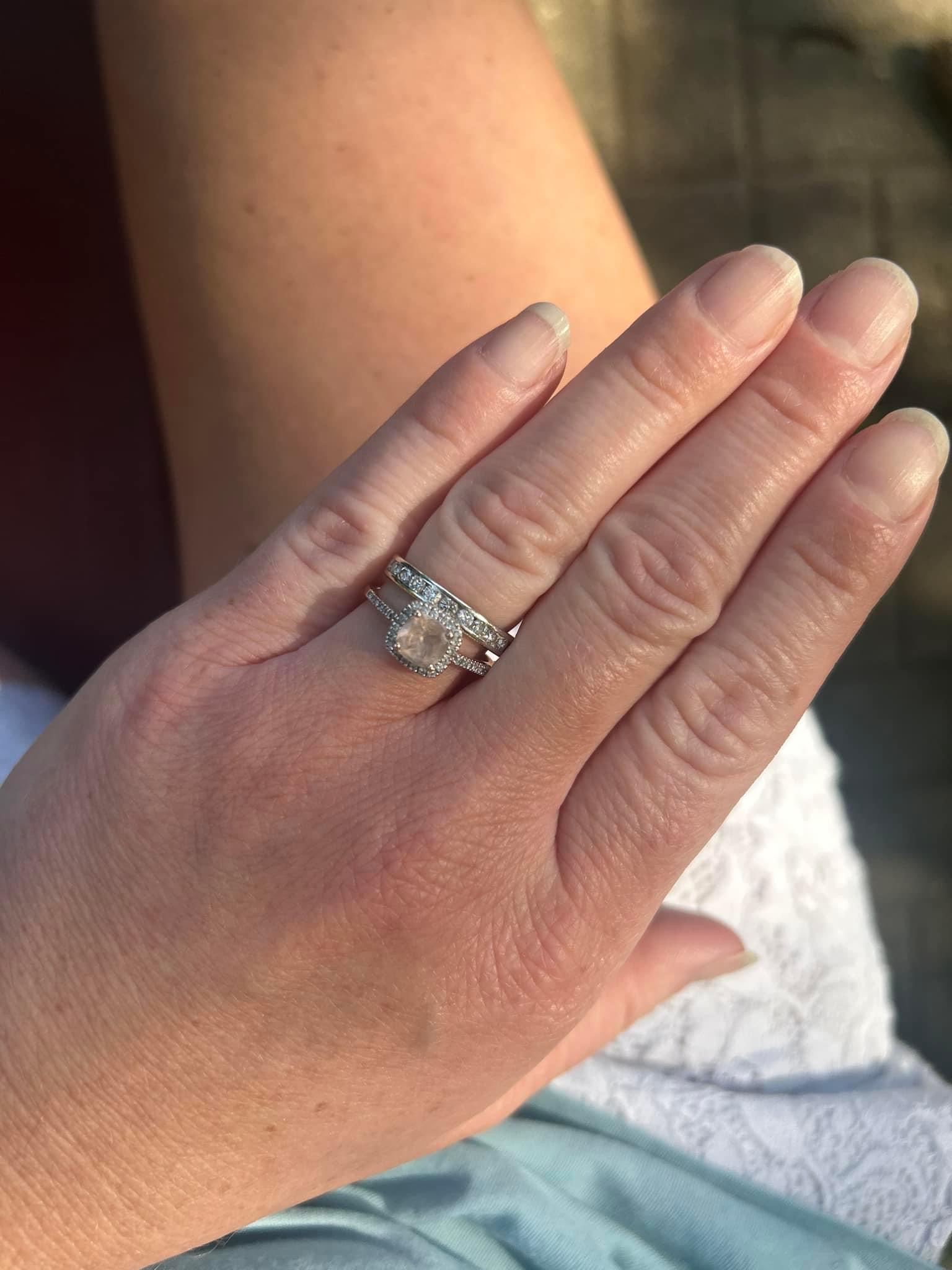 womans hand with a sparkly ring